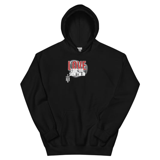 Black unisex hoodie with bold red and white lettering that reads “Love the Skin I’m In.”