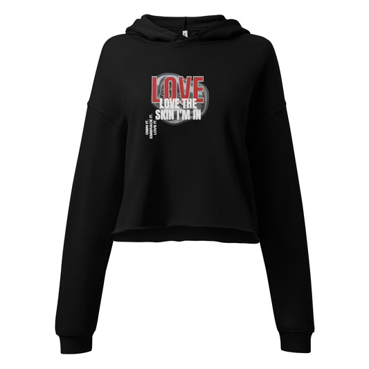 Black “Love the Skin I’m In” cropped hoodie, empowering self-love streetwear celebrating confidence and individuality.